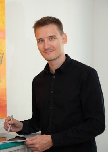 Ein Mann hält ein Tablet vor einem Gemälde, festgehalten in einer SEO-freundlichen Beschreibung mit relevanten Schlüsselwörtern.